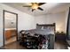 Spacious bedroom with a queen bed, ceiling fan, and a bathroom attached to the room at 12410 W Flores Dr, El Mirage, AZ 85335