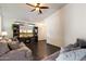 Spacious living room showcasing a media center with a fireplace and comfortable seating on hardwood floors at 12410 W Flores Dr, El Mirage, AZ 85335