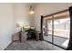 Bright office space with gray cabinets, desk, tile floors, and a sliding glass door that leads to the patio at 12410 W Flores Dr, El Mirage, AZ 85335