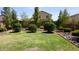 Lush backyard featuring green grass, decorative stone, and well-manicured bushes at 1309 W Park St, Phoenix, AZ 85041