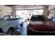 Spacious three-car garage containing two vintage cars and lots of wall decor at 1309 W Park St, Phoenix, AZ 85041
