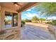View from back patio with stone flooring, featuring gorgeous landscaping and common area beyond at 15101 W Waterford Dr, Surprise, AZ 85374