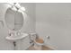 Bathroom featuring a pedestal sink, toilet, and modern lighting at 15101 W Waterford Dr, Surprise, AZ 85374