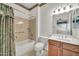 Bathroom with tub and shower combo, toilet, and wood vanity with sink at 15101 W Waterford Dr, Surprise, AZ 85374