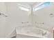 Clean bathroom featuring a soaking tub with a marble countertop and light-filled window at 15101 W Waterford Dr, Surprise, AZ 85374