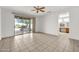 Bright bedroom with tile floors, ceiling fan, and sliding doors to backyard patio at 15101 W Waterford Dr, Surprise, AZ 85374