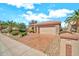 Charming single-story home featuring a spacious driveway, desert landscaping, and a two car garage at 15101 W Waterford Dr, Surprise, AZ 85374