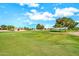 Golf course view featuring green grass, mature trees, and blue skies at 15101 W Waterford Dr, Surprise, AZ 85374