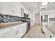 Well-equipped kitchen with granite countertops, stainless steel appliances, and stylish backsplash at 15101 W Waterford Dr, Surprise, AZ 85374