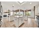 Spacious kitchen featuring dual islands, stainless appliances, tile flooring, and ample natural light at 15101 W Waterford Dr, Surprise, AZ 85374