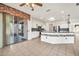 Open concept living and kitchen area with island and stainless steel appliances at 15101 W Waterford Dr, Surprise, AZ 85374