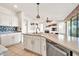 Updated kitchen featuring a spacious island with stainless steel dishwasher and granite countertops at 15101 W Waterford Dr, Surprise, AZ 85374