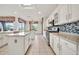 Open-concept kitchen with dual islands, stainless appliances, stylish backsplash and tile flooring at 15101 W Waterford Dr, Surprise, AZ 85374