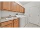 Laundry room featuring a sink, counter space, cabinets, and modern appliances at 15101 W Waterford Dr, Surprise, AZ 85374