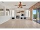 Inviting living room with fireplace, built-in shelving, and sliding door access to the patio at 15101 W Waterford Dr, Surprise, AZ 85374