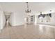 Spacious living room with tile flooring, chandelier, and windows providing natural light at 15101 W Waterford Dr, Surprise, AZ 85374
