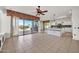 Open-concept living area with tile flooring and a seamless flow into the kitchen at 15101 W Waterford Dr, Surprise, AZ 85374