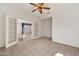 Bright living area with tile floors and a view into a parlor with glass french doors at 15101 W Waterford Dr, Surprise, AZ 85374