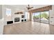 Spacious living room with fireplace, built-in features, sliding glass doors to patio and tile flooring at 15101 W Waterford Dr, Surprise, AZ 85374