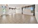Spacious living room with tile flooring, decorative windows, and neutral color scheme at 15101 W Waterford Dr, Surprise, AZ 85374