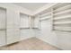 Large walk-in closet with custom shelving and storage solutions at 15101 W Waterford Dr, Surprise, AZ 85374