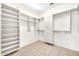 Bright walk-in closet features custom shelving, rods, and drawer storage at 15101 W Waterford Dr, Surprise, AZ 85374