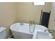 Bathroom featuring a standalone tub, modern fixtures, and neutral tones at 15221 N Clubgate Dr # 2044, Scottsdale, AZ 85254