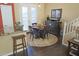 Dining area featuring a round table set for four, adjacent to a kitchen island at 15221 N Clubgate Dr # 2044, Scottsdale, AZ 85254