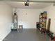 Spacious garage featuring epoxy flooring, ample shelving, and a utility sink at 15221 N Clubgate Dr # 2044, Scottsdale, AZ 85254