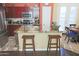 Kitchen island featuring granite countertop, breakfast bar seating, and stainless steel sink at 15221 N Clubgate Dr # 2044, Scottsdale, AZ 85254