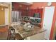 Kitchen with dark wood cabinets, stainless steel appliances, and a granite countertop island with seating at 15221 N Clubgate Dr # 2044, Scottsdale, AZ 85254