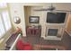 Bright living room with fireplace and mantle, ceiling fan, and dark hardwood floors at 15221 N Clubgate Dr # 2044, Scottsdale, AZ 85254
