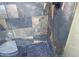 Shower with multi-tone stone-look tile, river rock floor and a ceiling mounted shower head at 15221 N Clubgate Dr # 2044, Scottsdale, AZ 85254