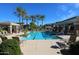 Resort-style community pool surrounded by palm trees, comfortable lounge chairs, offering a relaxing and luxurious atmosphere at 15221 N Clubgate Dr # 2044, Scottsdale, AZ 85254