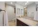 Bathroom vanity with a dark wood cabinet, mirror, and stone tile backsplash at 15802 N 71St St # 552, Scottsdale, AZ 85254