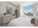 Bedroom with a window view, dresser, and leafy decorative plants at 15802 N 71St St # 552, Scottsdale, AZ 85254