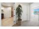 Hallway view showing bathroom, potted plant, door, and carpeted bedroom in the distance at 15802 N 71St St # 552, Scottsdale, AZ 85254