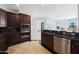 Well-equipped kitchen with dark wood cabinets, granite counters, and an open design at 15802 N 71St St # 552, Scottsdale, AZ 85254