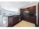 Modern kitchen with dark cabinetry, stainless steel appliances, and open access to the living area at 15802 N 71St St # 552, Scottsdale, AZ 85254