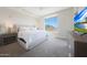 A bright and airy primary bedroom boasts a plush king-sized bed and a beautiful view at 15802 N 71St St # 552, Scottsdale, AZ 85254