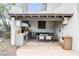 Outdoor kitchen with a built-in grill, dining area, and ample counter space for convenient entertaining at 15802 N 71St St # 552, Scottsdale, AZ 85254
