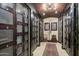 Elegant wine cellar featuring custom storage with metal doors, tiled flooring, and warm lighting for an inviting ambiance at 15802 N 71St St # 552, Scottsdale, AZ 85254
