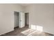 A cozy bedroom with neutral carpet, a closet, and an open door at 16846 N 49Th Way, Scottsdale, AZ 85254
