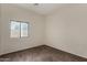 A simple bedroom featuring neutral walls, carpet, and a window letting in natural light at 16846 N 49Th Way, Scottsdale, AZ 85254