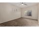 Bright bedroom with neutral walls, carpet flooring, ceiling fan, and a window at 16846 N 49Th Way, Scottsdale, AZ 85254