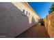 Exterior view of the property showing a stucco wall with trim windows and desert rock at 16846 N 49Th Way, Scottsdale, AZ 85254