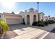 Attractive single-Gathering home with a beige exterior, arched entryway and concrete driveway at 16846 N 49Th Way, Scottsdale, AZ 85254