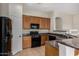Well-lit kitchen featuring wooden cabinets, black appliances, and stylish countertops at 16846 N 49Th Way, Scottsdale, AZ 85254