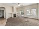 Cozy living room with a fireplace, sliding glass doors, and a ceiling fan at 16846 N 49Th Way, Scottsdale, AZ 85254