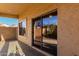 Covered patio with tinted sliding glass door and window overlooking a lush garden at 16846 N 49Th Way, Scottsdale, AZ 85254